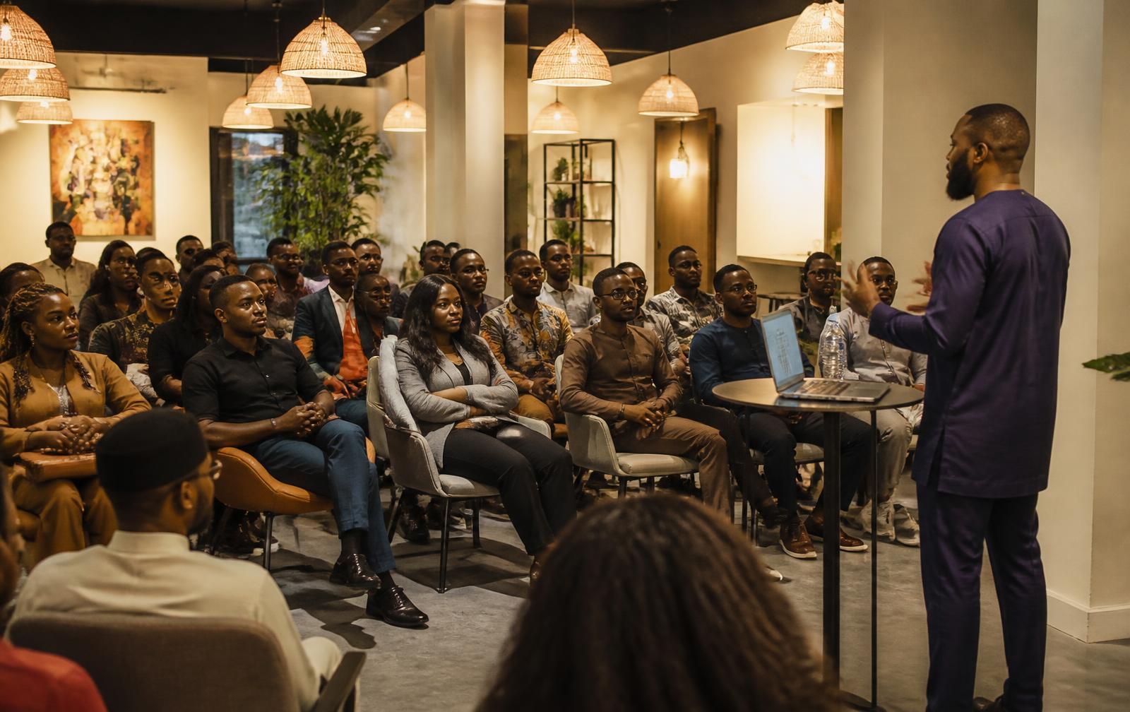 Founders and creatives seated together at an evening community gathering at The Cubicle